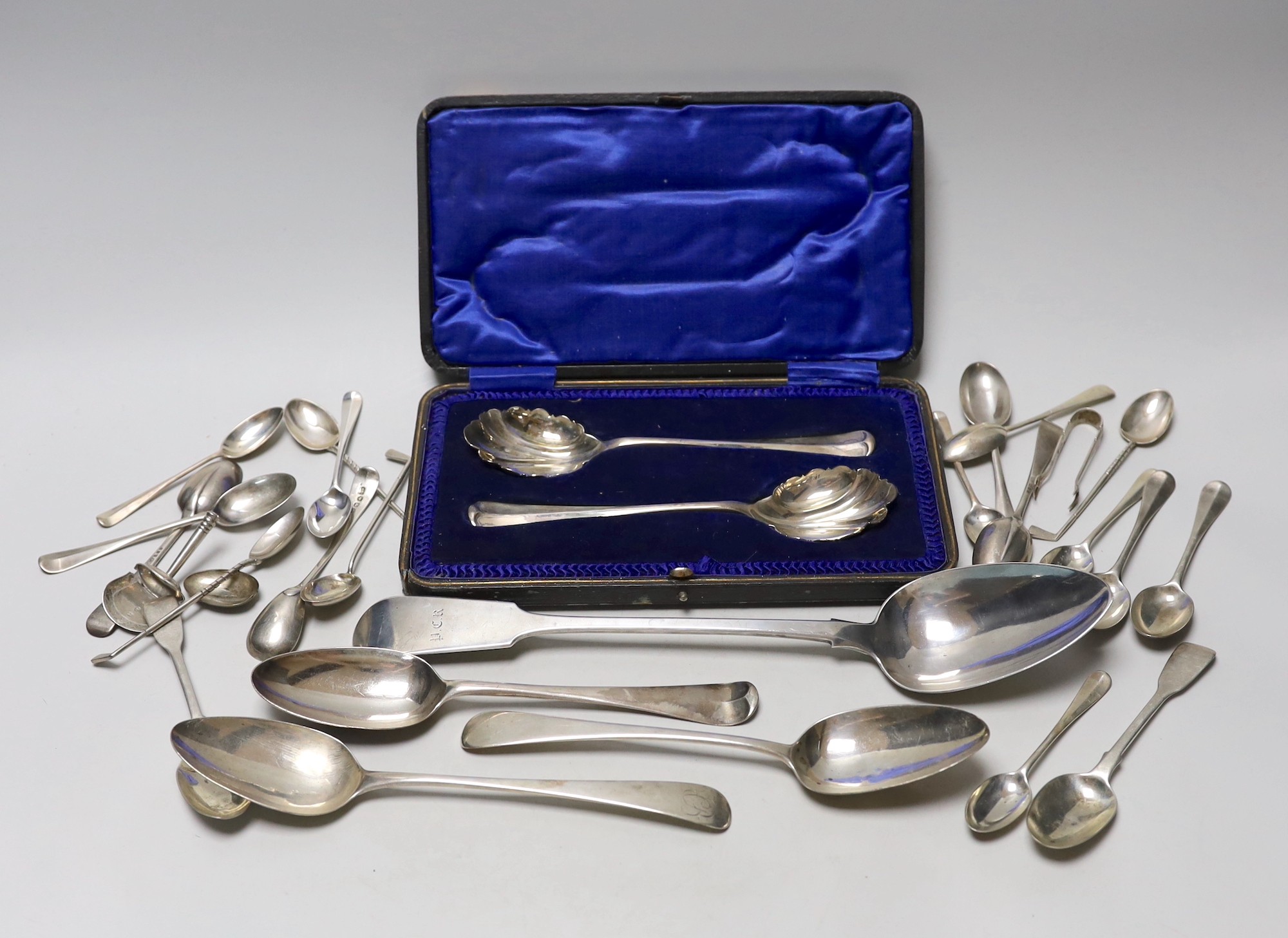 A Victorian Irish silver fiddle pattern basting spoon, Dublin, 1844, three George III tablespoons, a pair of later cased serving spoons and sundry tea, coffee and golf spoons, 23.7oz.